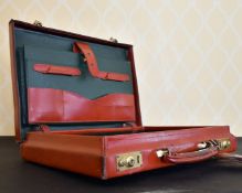 A LEATHER BRIEFCASE.