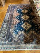 A GOOD PERSIAN RUG with three diamond shaped medallions. 7ft 9ins x 5ft 2ins.