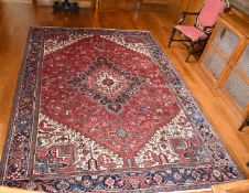 A LARGE GOOD PERSIAN CARPET with large central medallion, mainly in reds and blues. 12ft x 9ft
