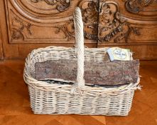 A WICKER LOG BASKET.