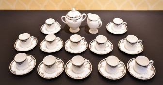 A SET OF TWELVE WEDGWOOD BONE CHINA CUPS AND SAUCERS, along with a sugar basin and milk jug (26).