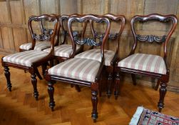 A SET OF SIX VICTORIAN ROSEWOOD SINGLE CHAIRS with shaped backs, drop-in seats, on turned legs.