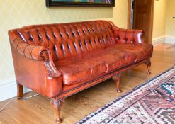A SUPERB BUTTONED BACK LEATHER SOFA with scroll ends, on mahogany cabriole legs ending in pad