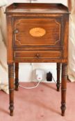 A MAHOGANY BEDSIDE CUPBOARD with drawer and panel door, on turned legs. 1ft 3ins diameter.
