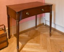 A LATE REGENCY GILLOW MAHOGANY PLAIN CONCAVE FRONTED SIDE TABLE with long frieze drawer, on turned