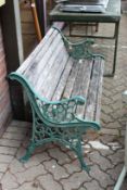 A cast metal and wooden slatted garden bench