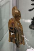 A small carved seated deity possible rhino horn