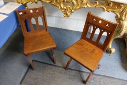 A good pair of Gothic Revival 19th century oak hall chairs with X shaped supports