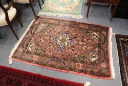 A small pink ground Persian design rug