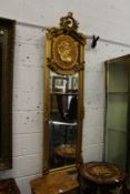 A pair of tall narrow decorative giltwood mirrors