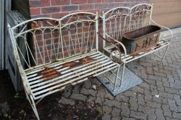 A pair of wrought iron benches