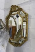 A good 19th century gilt framed mirror of octagonal outline with carved decoration