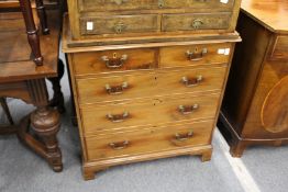 A small George III mahogany chest of two short and three graduated long drawers on bracket feet