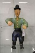 Carved and painted folk art figure of a man wearing a hat arms outstretched