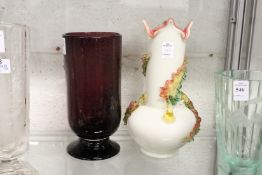 An amethyst coloured glass vase and another decorative glass vase