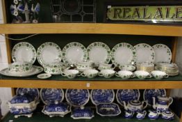 A large quantity of green vine patterned dinnerware various makers