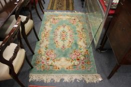 A small green ground floral rug