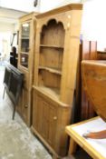 A large pine standing corner cupboard with shelves