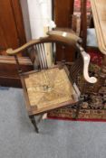 A mahogany and rush seated corner armchair