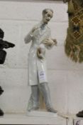 Lladro porcelain group of a vet holding a puppy dog