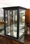 An early 20th century ebonised table top shop display cabinet