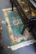 A small green Chinese rug
