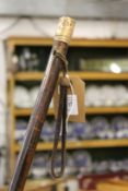 A dandy cane with gilt metal top