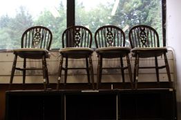 A set of four modern wheelback dining chairs