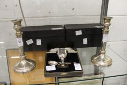 A pair of silver candlesticks and a silver christening set