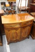 An inlaid mahogany bow front tv cabinet
