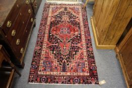 A Persian style rug pink ground with stylised decoration