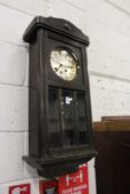 An oak cased drop dial wall clock