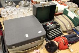 A reel to reel tape machine and two old typewriters