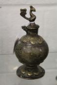 A small Eastern bronze vessel mounted with a bird