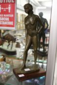 A bronze effect model of a standing female nude