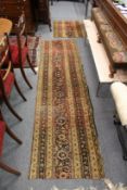 A small Persian rug, cut and worn together with two part runners