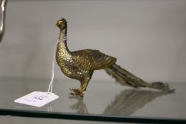 A gilt metal silvered model of a peacock