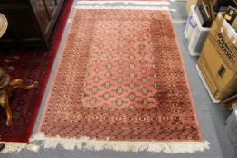 A modern pink ground Persian style rug