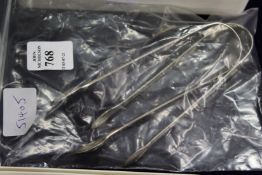 Two silver sugar tongs