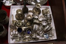 A good collection of small silver ware to include candlesticks napkin rings trophy cups etc