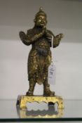 A bronze statue of a Chinese warrior or guardian