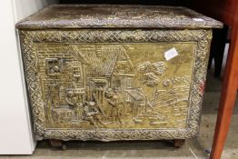 An embossed brass coal box