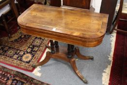 A good Regency rosewood and brass inlaid foldover card table