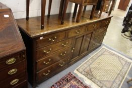 A good 19th century oak dresser with four frieze drawer above a central panelled cupboard door