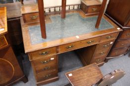 A Victorian walnut pedestal desk with a galleried upper section