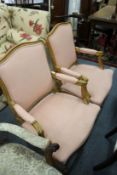 A pair of French style beech framed open armchairs