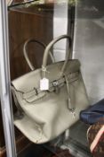 A ladies grey leather handbag