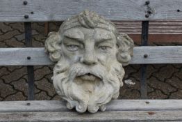 A reconstituted stone wall planter/fountain modelled as a mans head