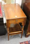 A small walnut drop flapped two tier table with a drawer to one end