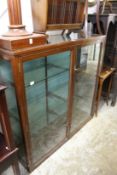 An early 20th century mahogany shop display cabinet